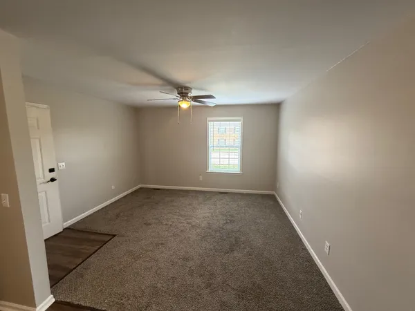 an empty room with a empty space and windows