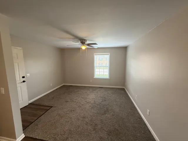 an empty room with a empty space and windows