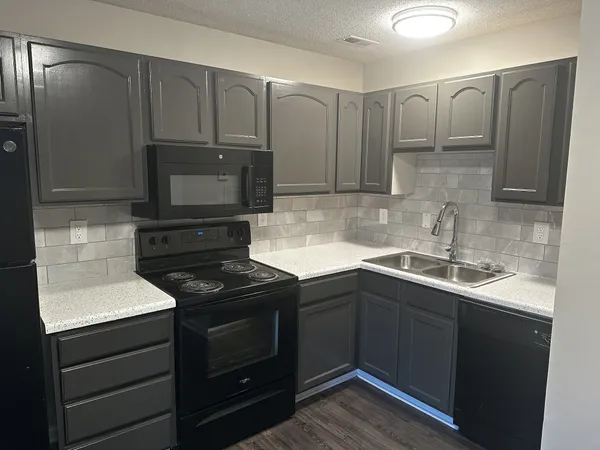 a kitchen with a sink and cabinets