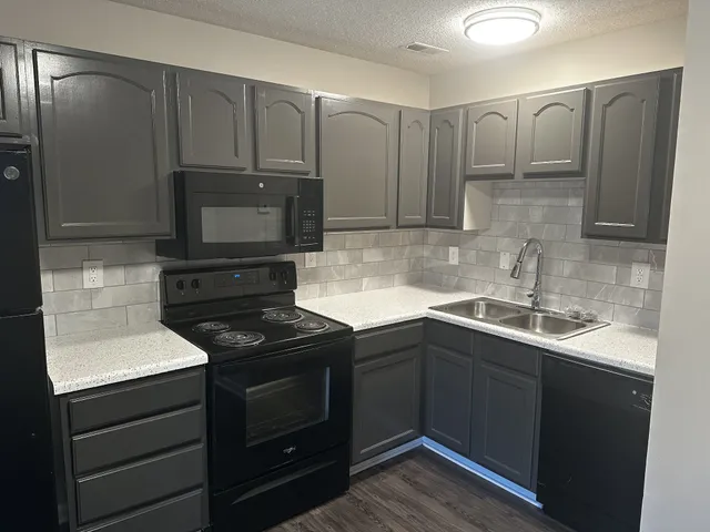 a kitchen with a sink and cabinets