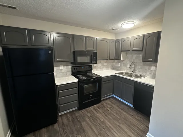 a kitchen with a refrigerator and a sink