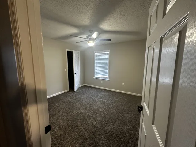 a view of empty room with windows and closet