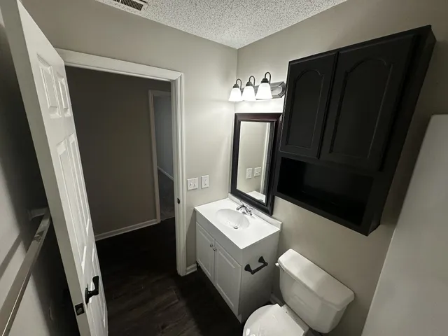 a bathroom with a sink toilet and mirror