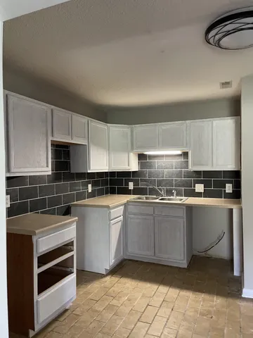 a kitchen with stainless steel appliances granite countertop a stove and a sink