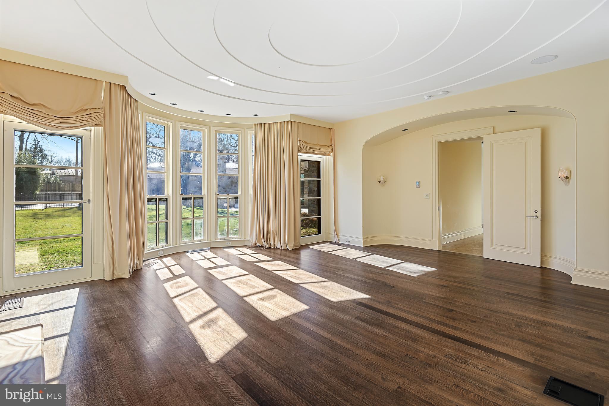 10111 Iron Gate Road Potomac, MD 20854 - Photo 43 of 94 a view of an empty room with wooden floor and a window