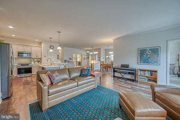 a living room with furniture and a kitchen view