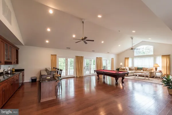 a view of a kitchen and dining room with wooden floor