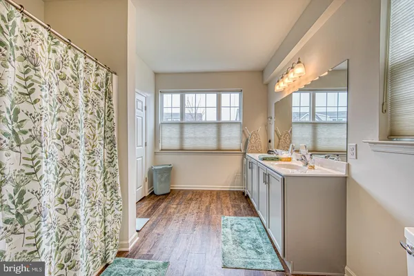 a kitchen with a sink and wooden floor