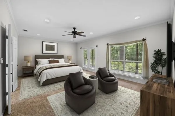 a bedroom with a bed and a large window