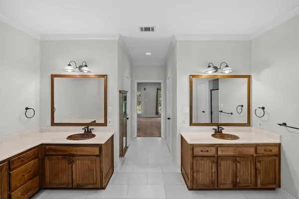 a spacious bathroom with a sink double vanity and a mirror