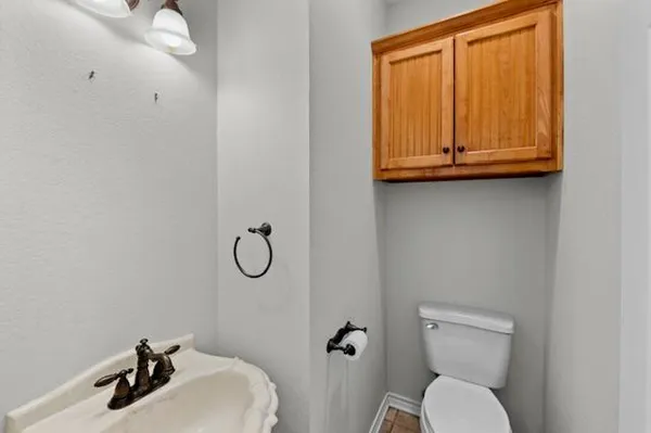 a bathroom with a toilet sink and mirror