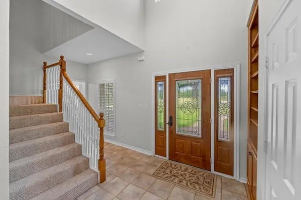 a view of entryway with wooden floor and stairs