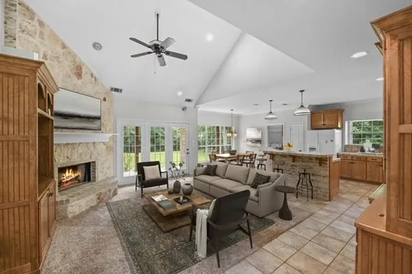 a living room with fireplace furniture and a fireplace
