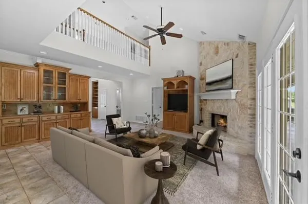 a living room with furniture a fireplace and a flat screen tv