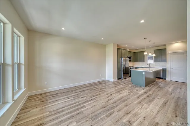 a kitchen with a sink stove and refrigerator