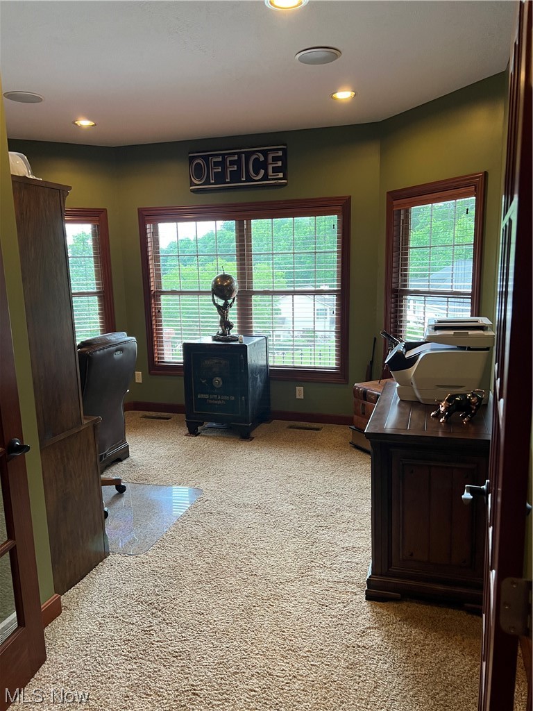 1457 Terrace Road Northwest New Philadelphia, OH 44663 - Photo 15 of 33 Home office with plenty of natural light and light colored carpet