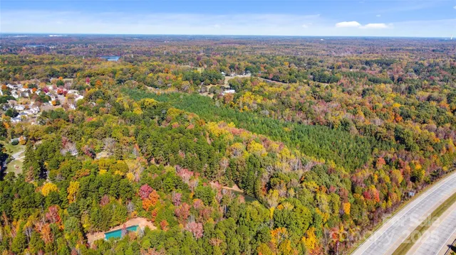 an aerial view of residential houses with city view