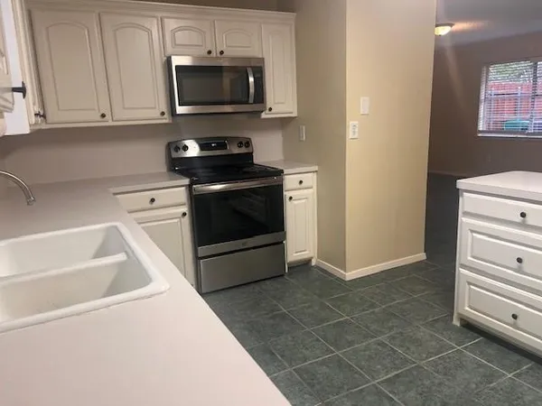 a kitchen with a stove and a microwave