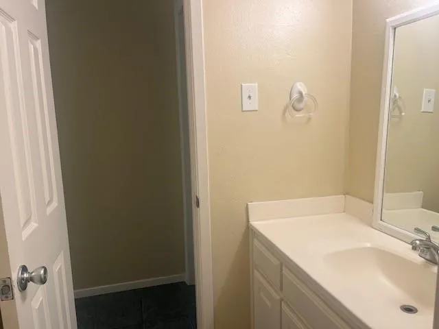 an empty room with windows and cabinet