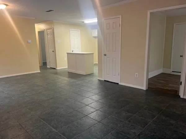 a view of a big room with wooden floor and windows