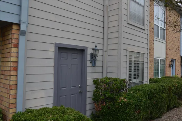 a view of a door and brick walls
