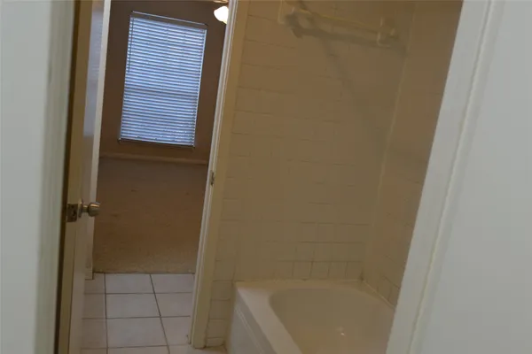 a kitchen with a sink a refrigerator and cabinets