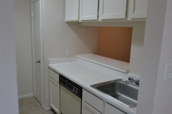 a kitchen with a sink and cabinets