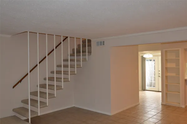 a view of entryway with stairs and wooden floor