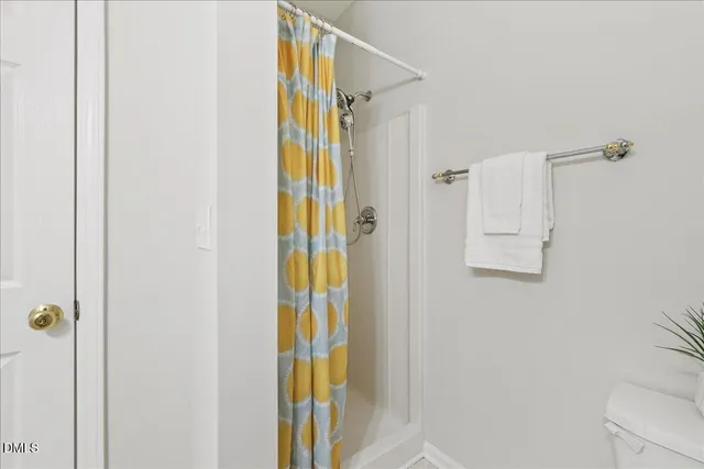 a bathroom with a shower and a door