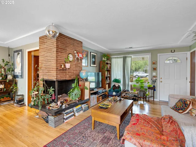 a living room with furniture floor to ceiling window and a table