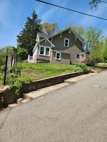 a front view of house with yard and green space