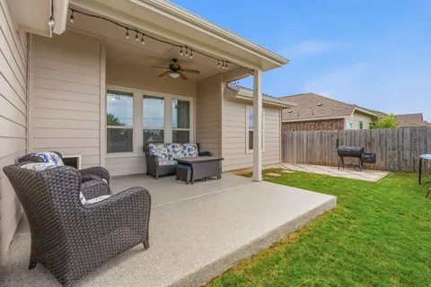 a view of a house with couches chairs and a yard
