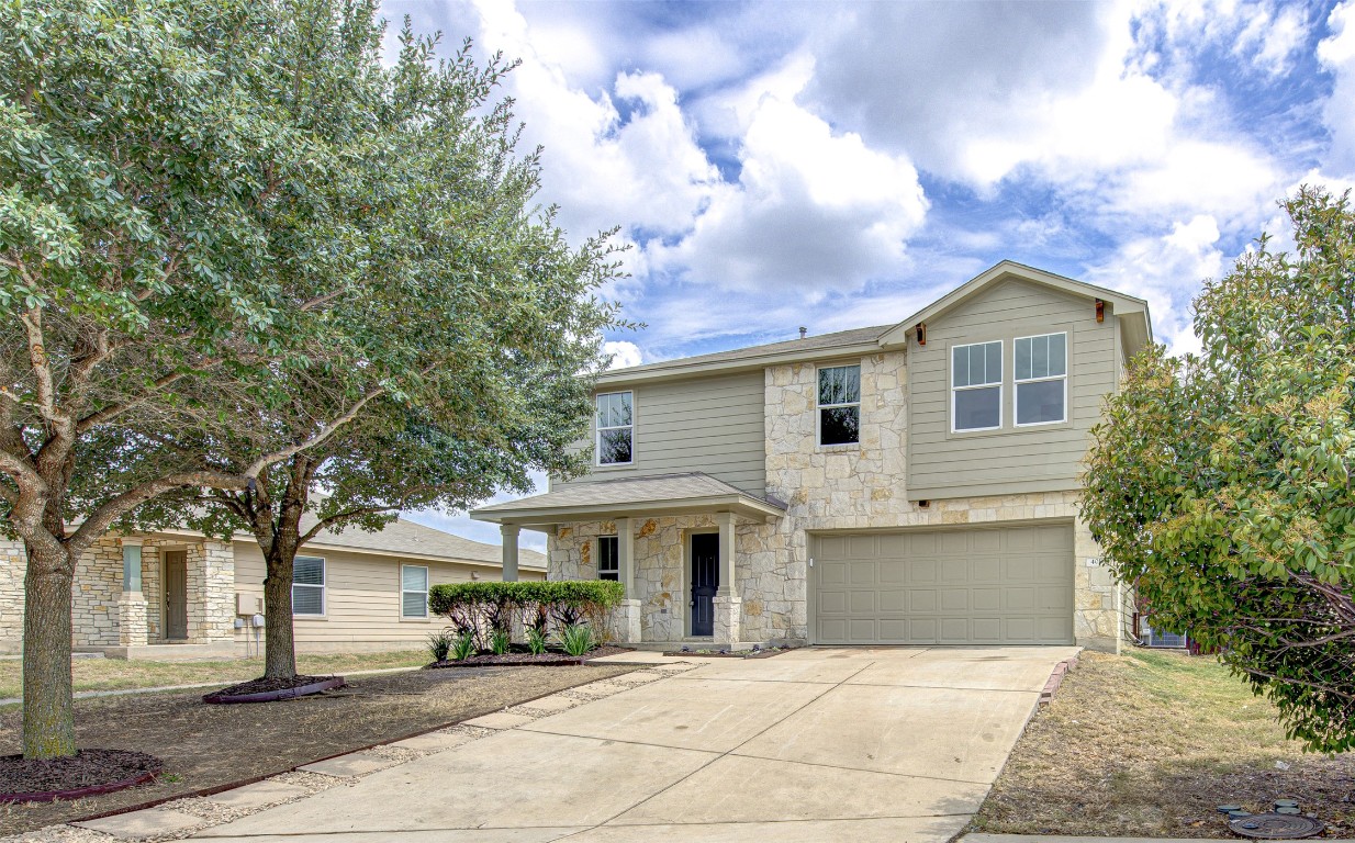 a front view of a house with a garden