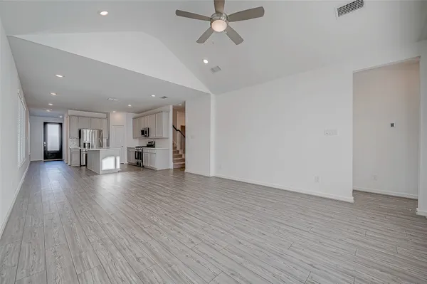 a view of an empty room and wooden floor