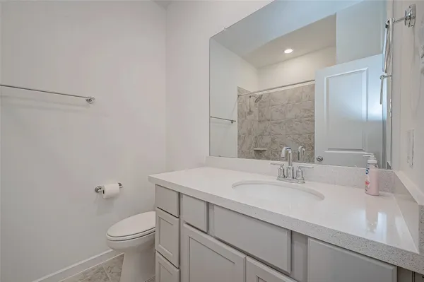 a bathroom with a sink toilet and mirror
