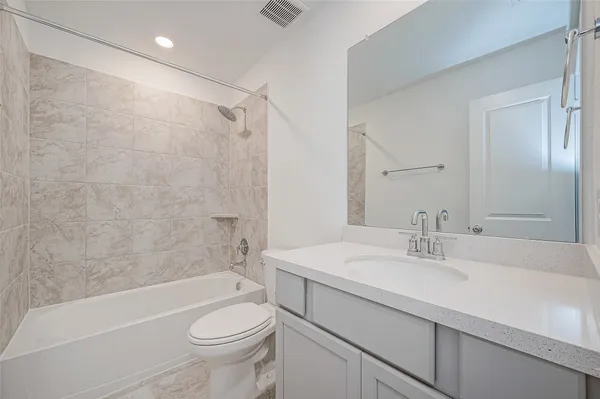 a bathroom with a sink vanity and a mirror