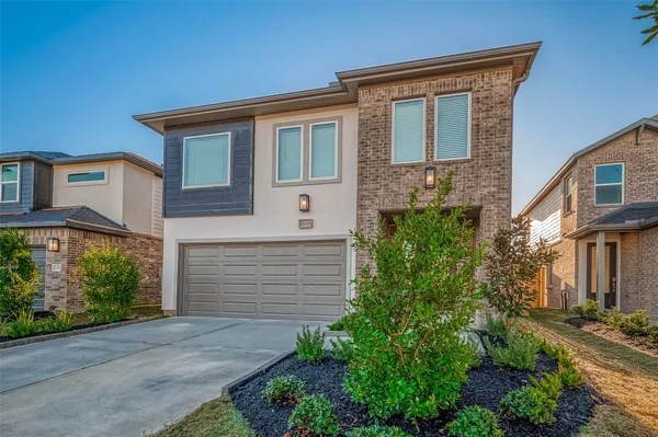 a front view of a house with garden