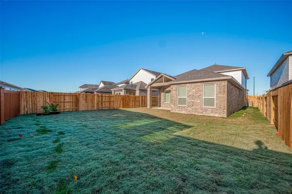 a front view of a house with a yard and outdoor seating