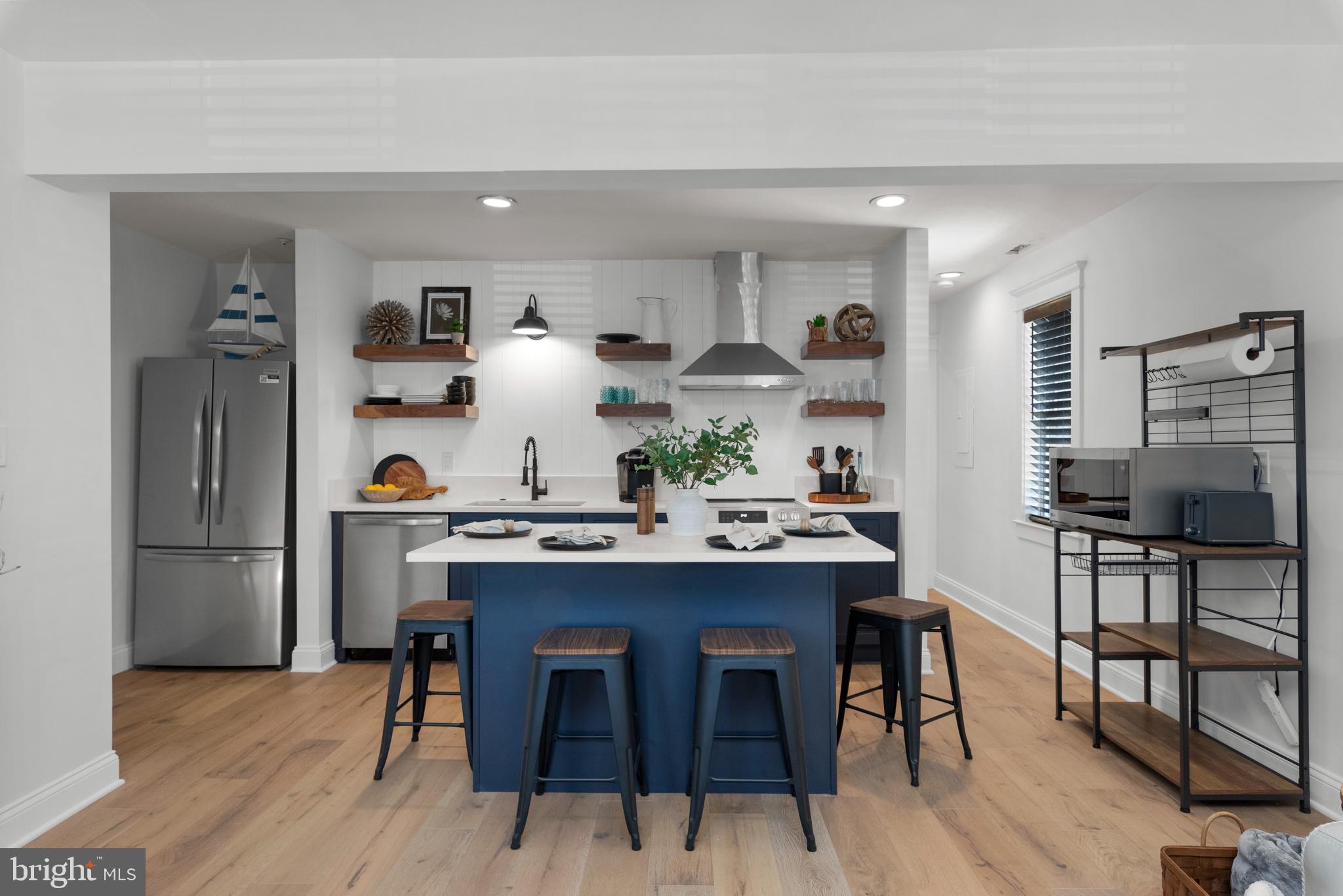 a view of a dining room kitchen with furniture and wooden floor