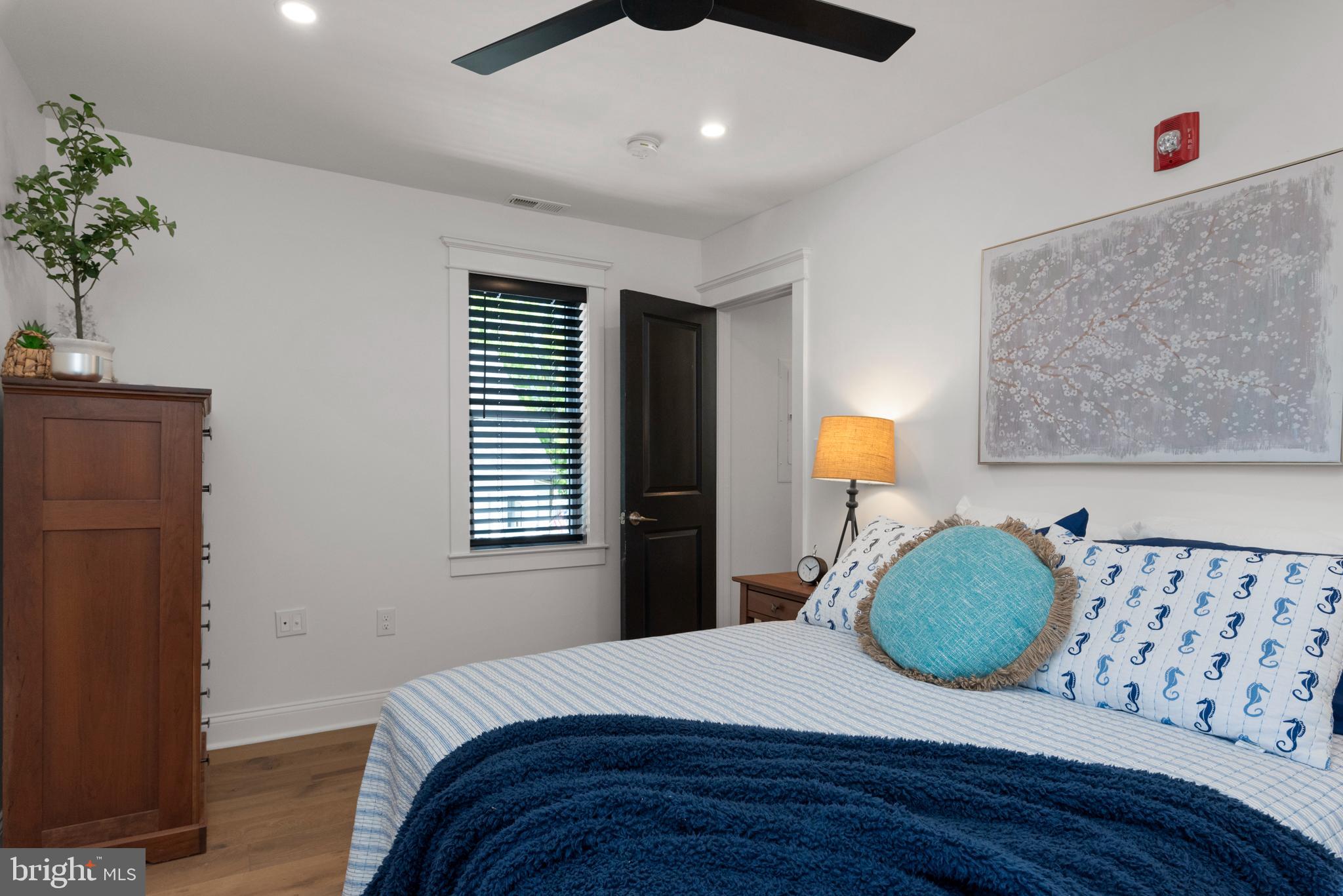 1000 West Street, Unit 200 Annapolis, MD 21401 - Photo 12 of 23 a bedroom with a large bed and a potted plant