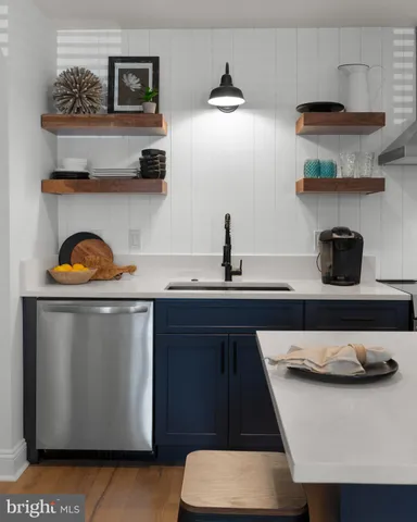 a kitchen with a refrigerator a stove and wooden floor