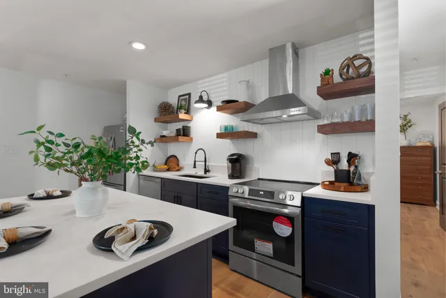 a kitchen with stainless steel appliances granite countertop a sink and a stove