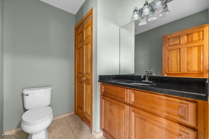 8 Kenvil Avenue Succasunna, NJ 07876 - Photo 5 of 21 a bathroom with a granite countertop sink toilet and mirror