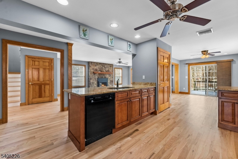 8 Kenvil Avenue Succasunna, NJ 07876 - Photo 6 of 21 a kitchen with stainless steel appliances granite countertop a stove and wooden floors