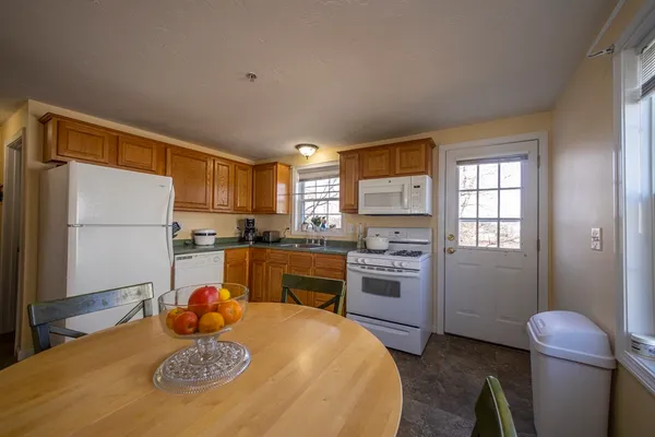a kitchen with a refrigerator and a stove top oven