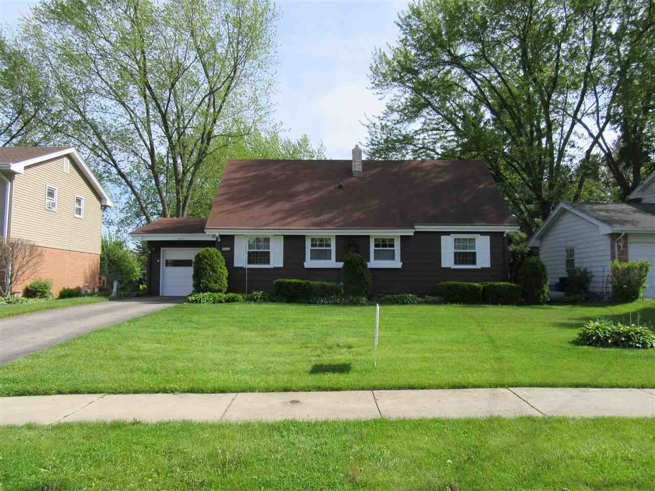 4045 Abbotsford Road Rockford, IL 61107 - Photo 1 of 18 a front view of a house with a yard