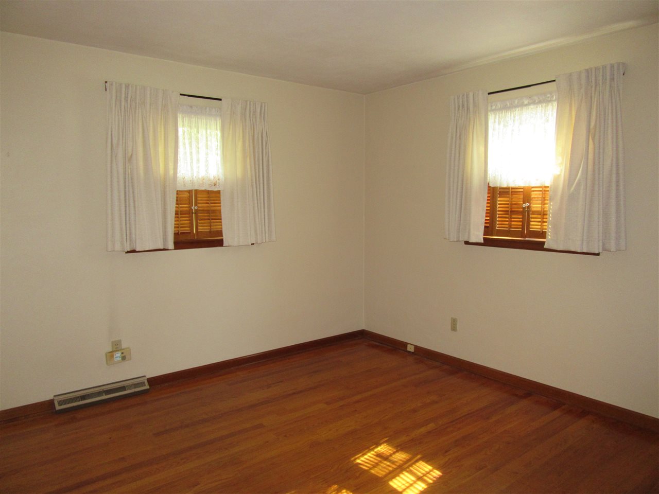 4045 Abbotsford Road Rockford, IL 61107 - Photo 8 of 18 an empty room with wooden floor and windows