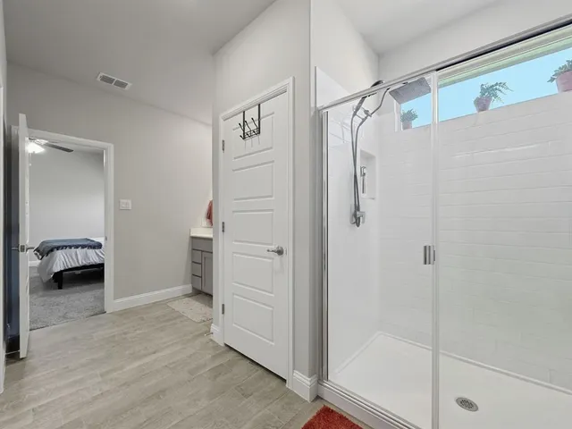 a bathroom with a toilet and a shower