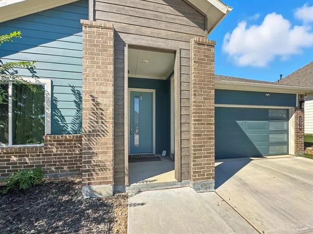 a kitchen with sink a refrigerator and chairs