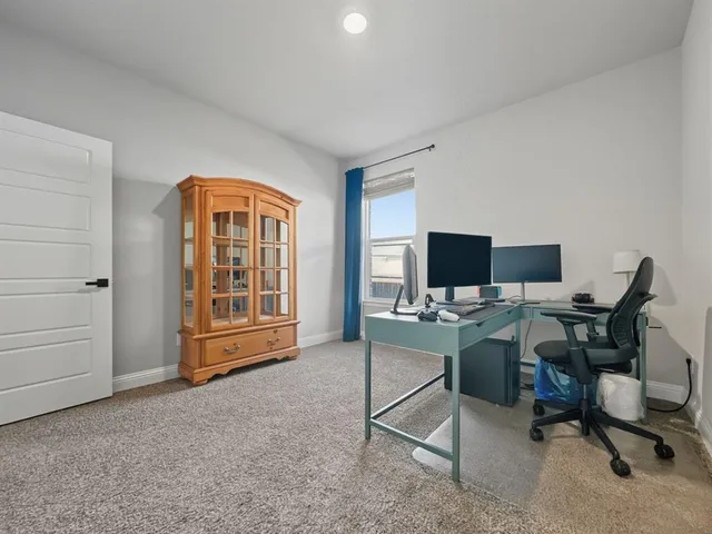 a room with a bed and a bathroom sink